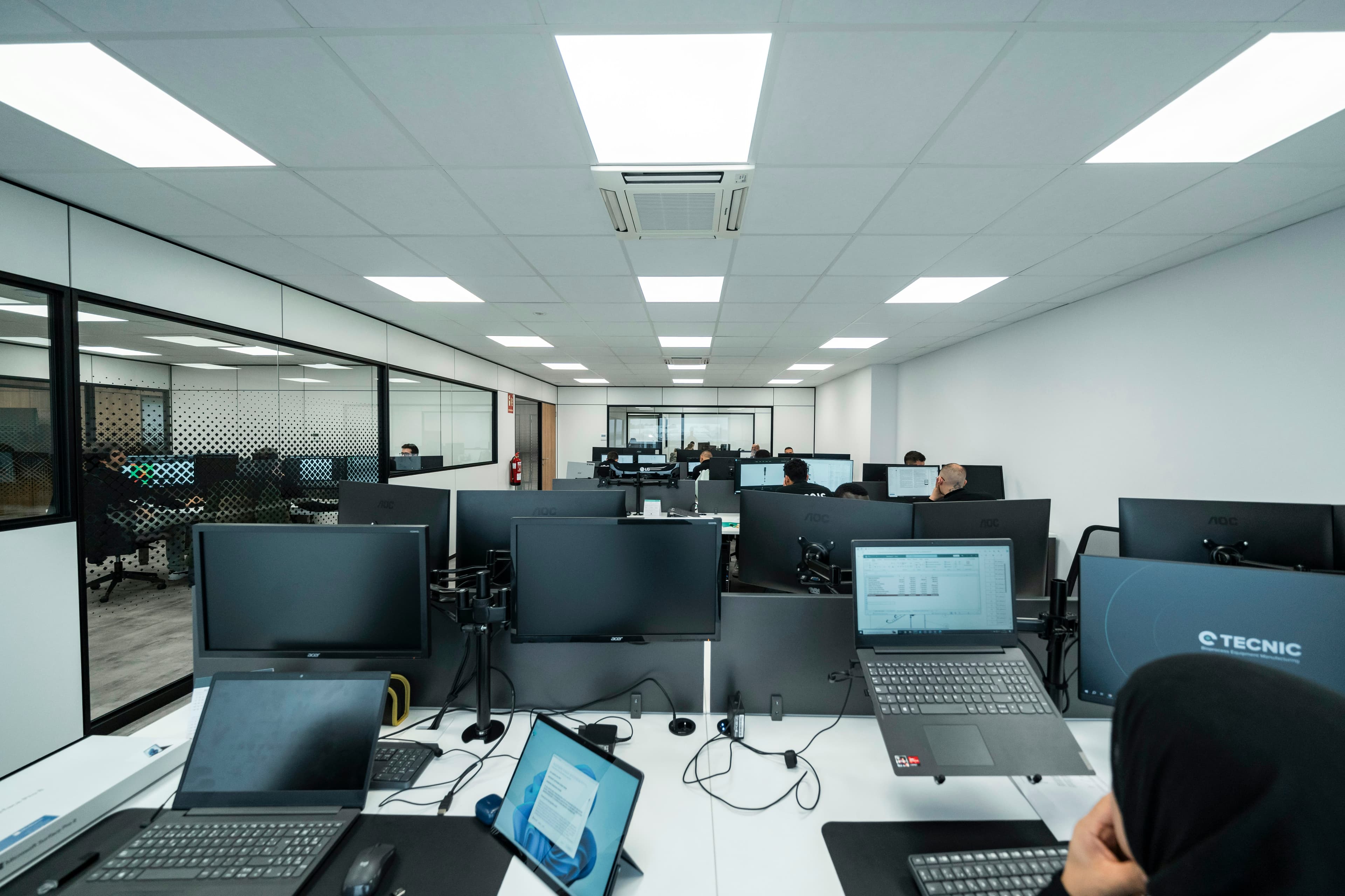 Technical team working on business computers in an office